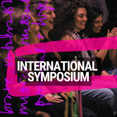 An image of an engaged, smiling, international audience with the text 'International symposium' across it